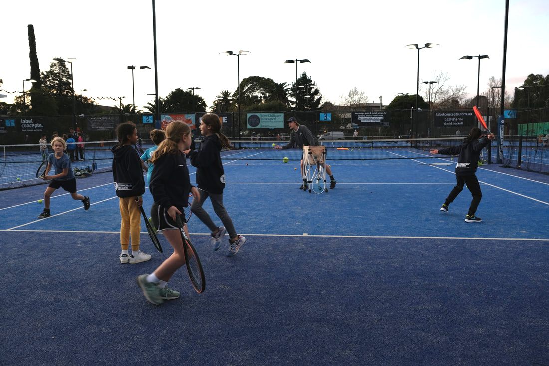 Junior players developing their tennis skills at Elsternwick Park
